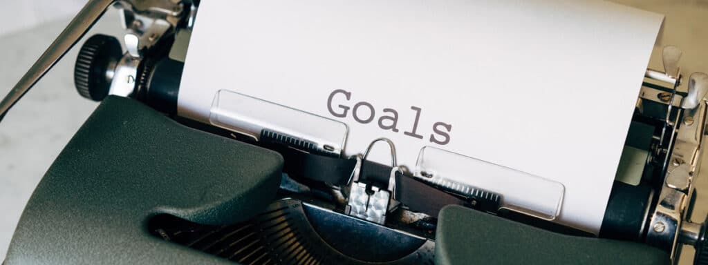 Das Wort „Goal“ mit einer Schreibmaschine getippt.